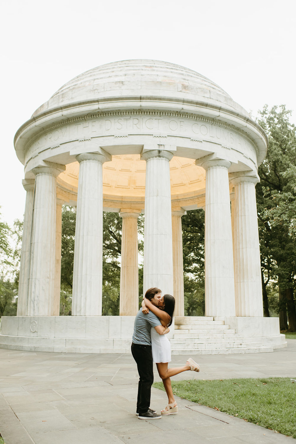 engagement photos dc war memorial couple kissing foot pop