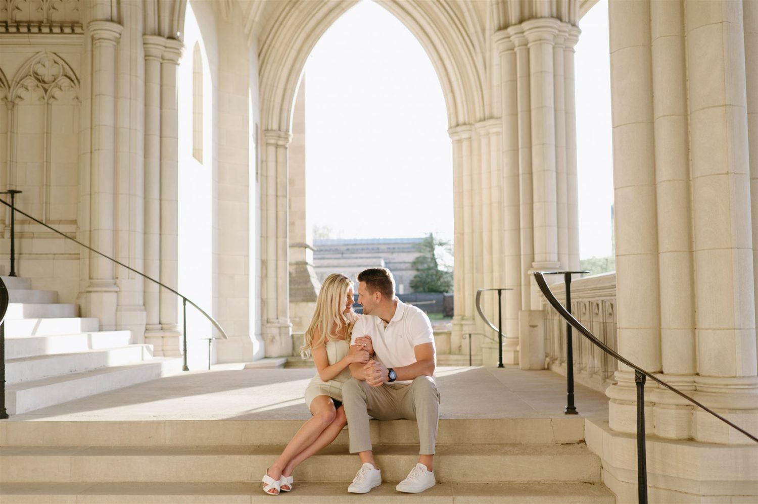 national cathedral engagement photos couple sitting on stairs