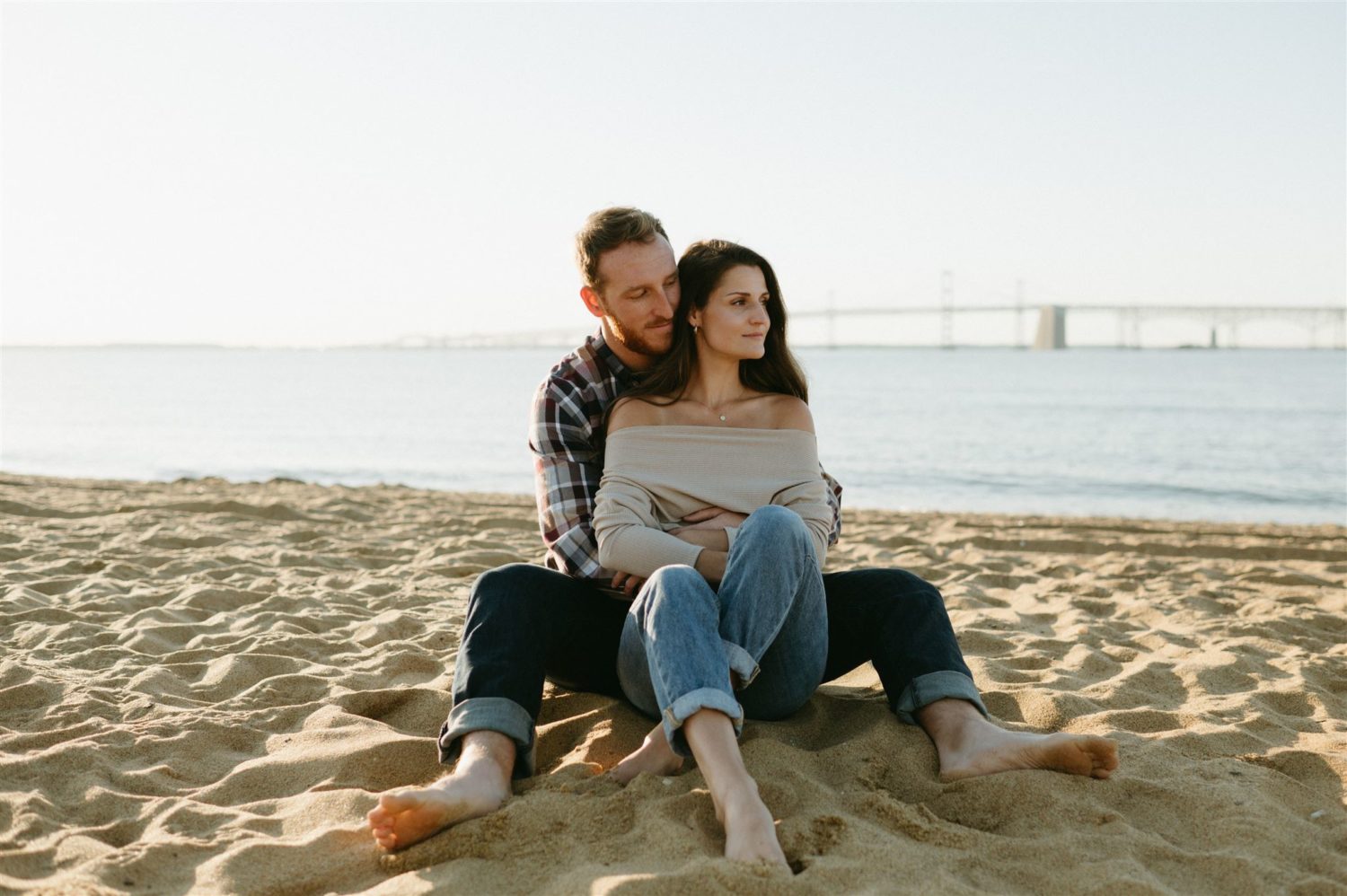 engagement session couple hugging beach