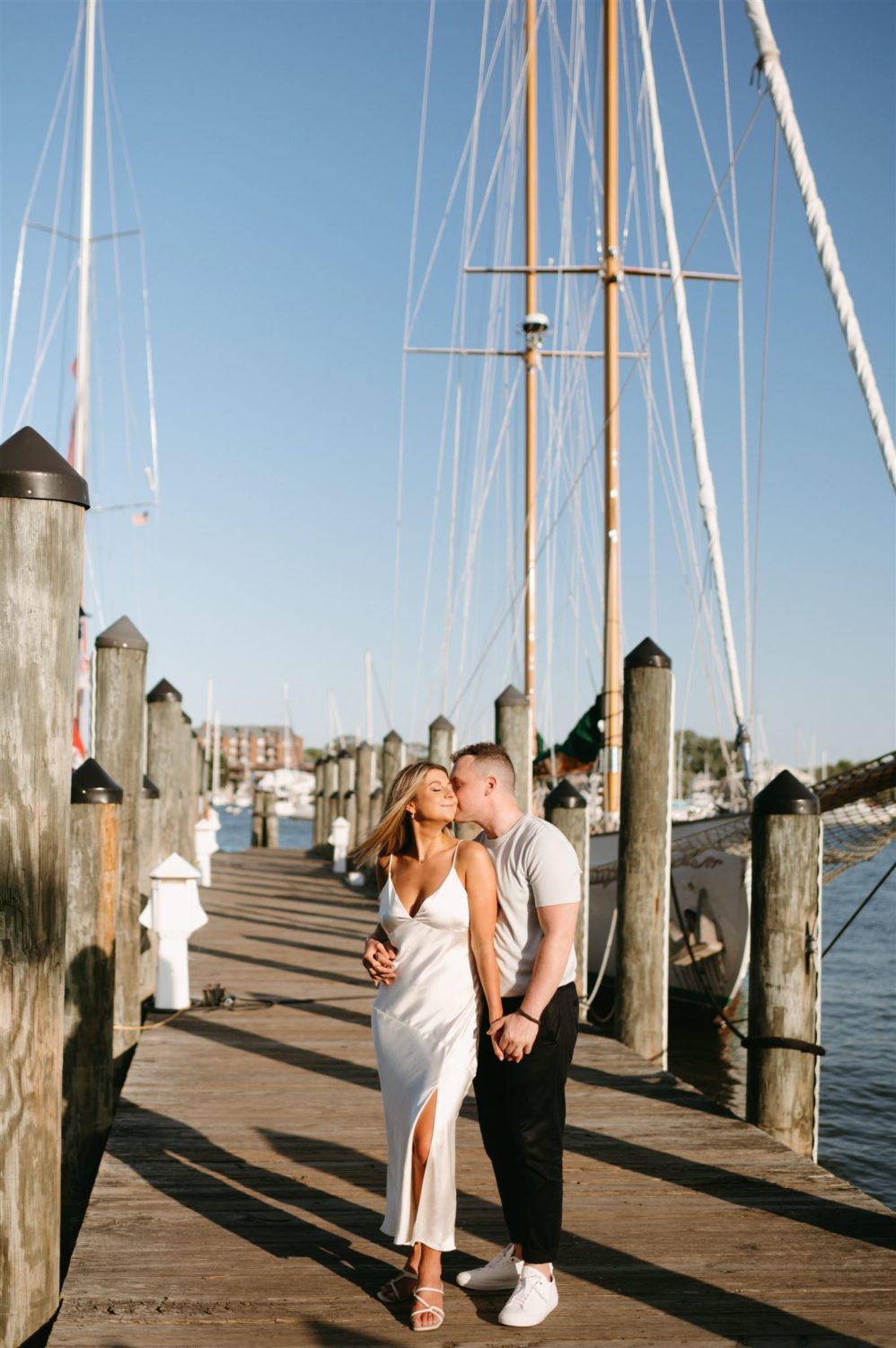 waterfront couple kissing engagement session