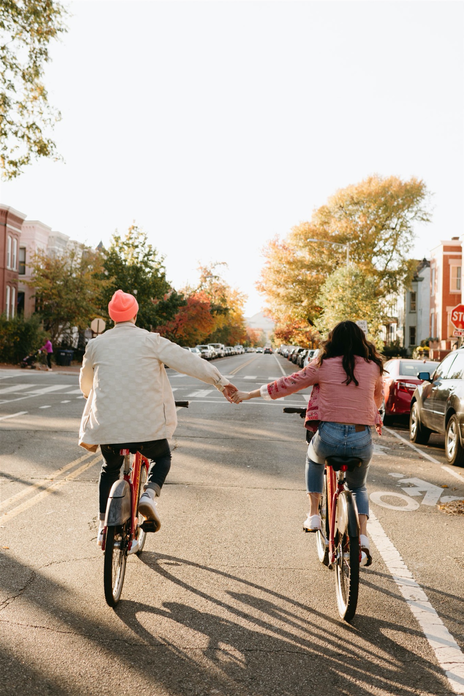 couple h street engagement session riding bikes holding hands