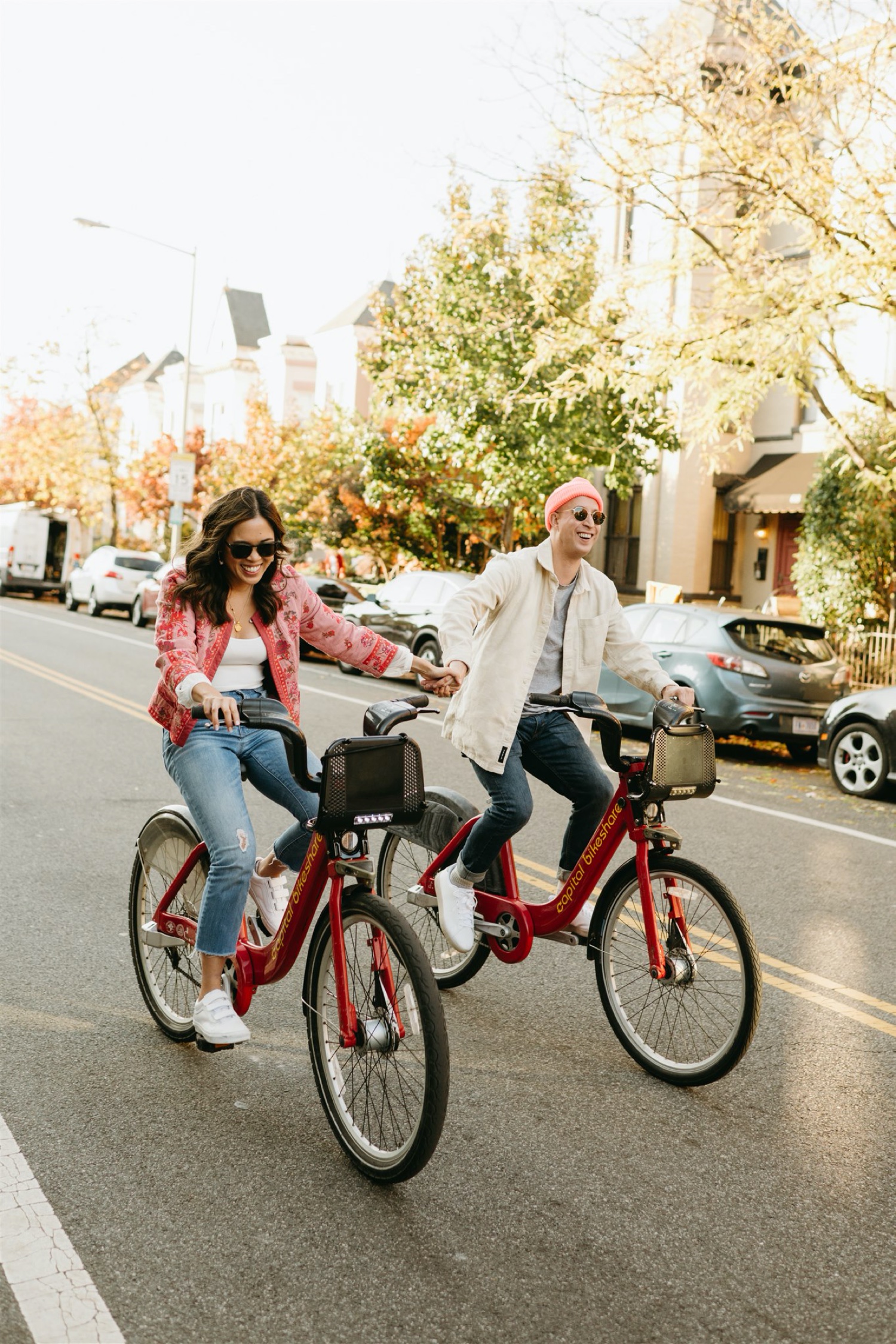 h street engagement session riding bikes couple smiling