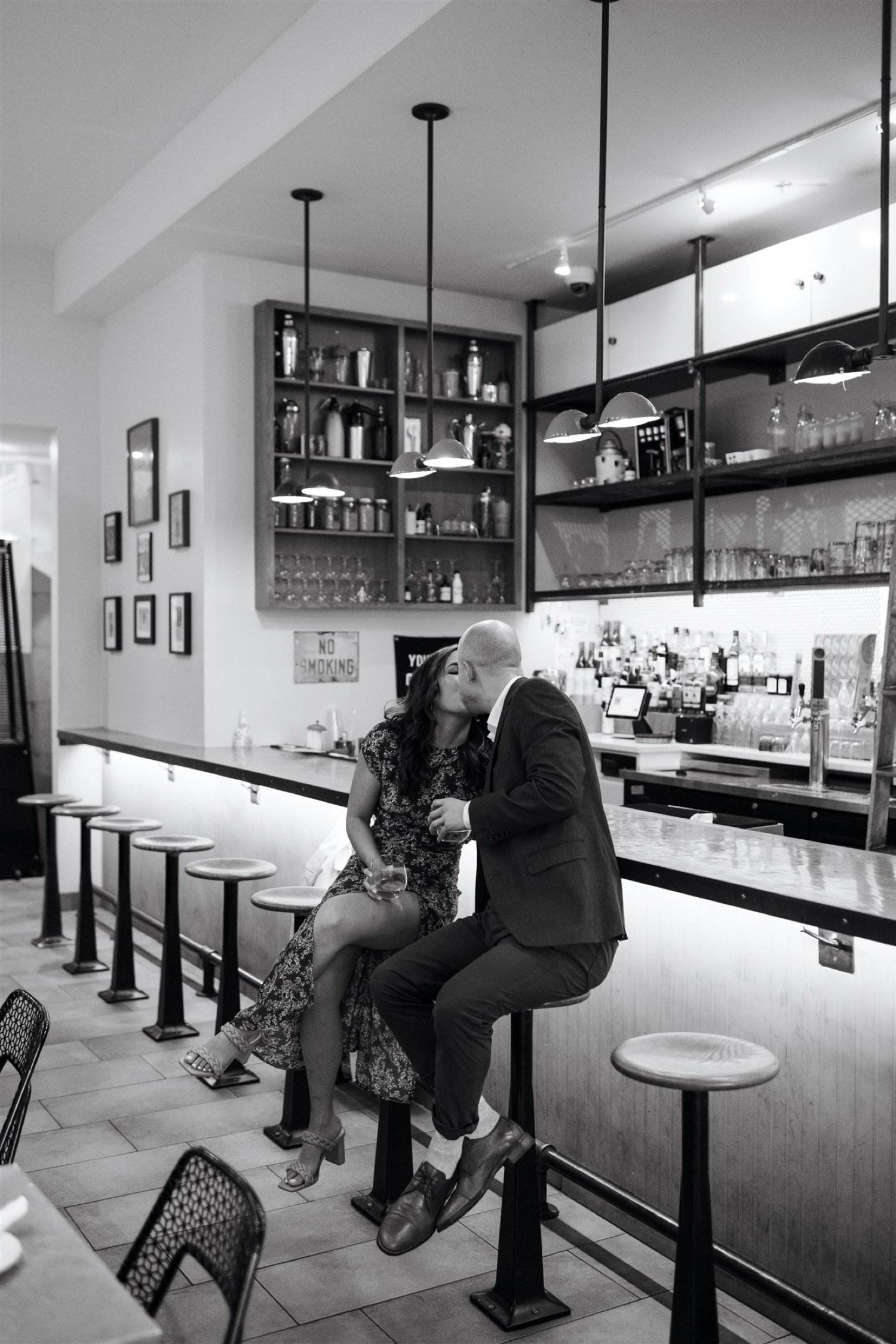 black and white couple kissing indoors bar