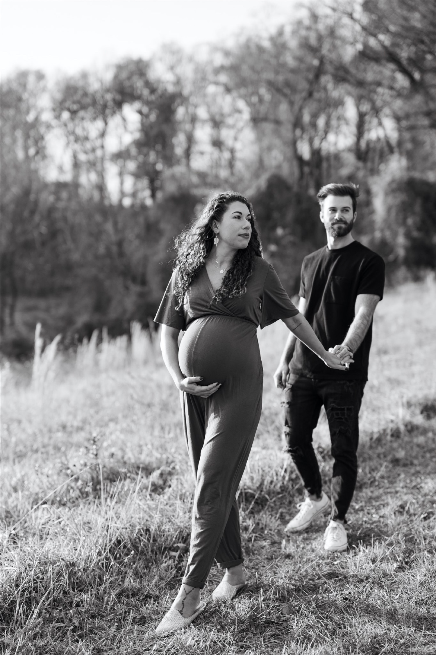black and white maternity session couple walking