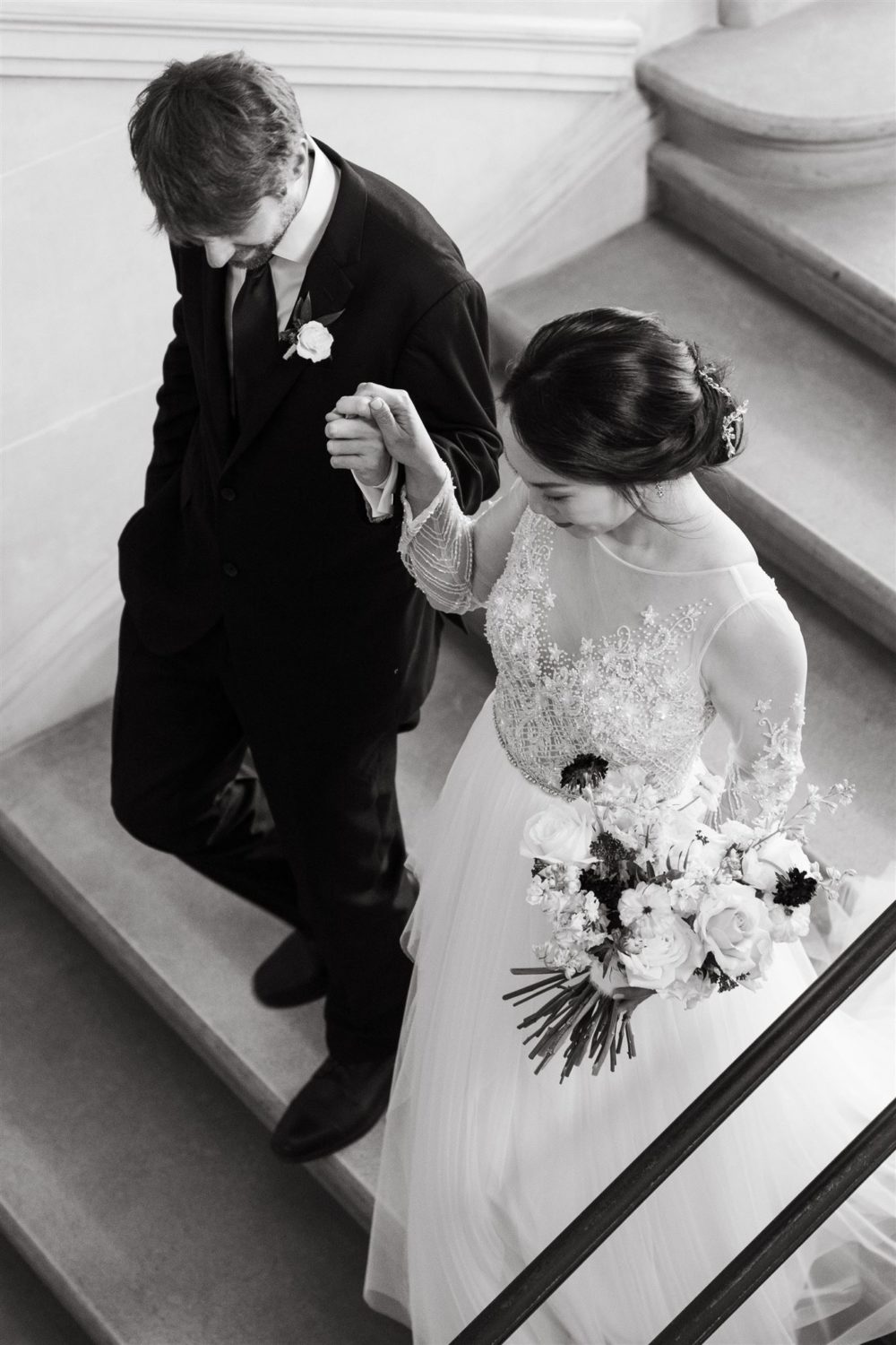 black and white second shooter bride and groom walking