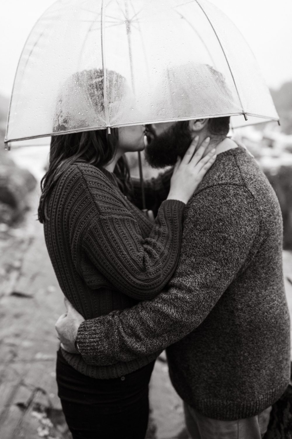rainy great falls engagement clear umbrella kissing