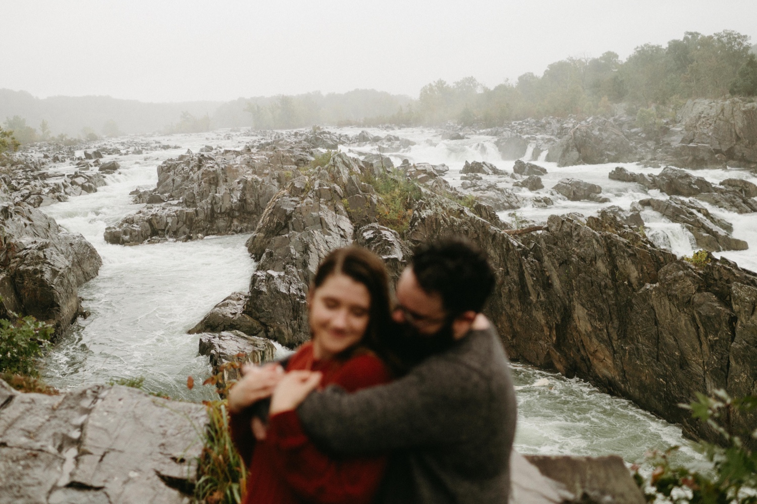 rainy great falls engagement couple blur river focus