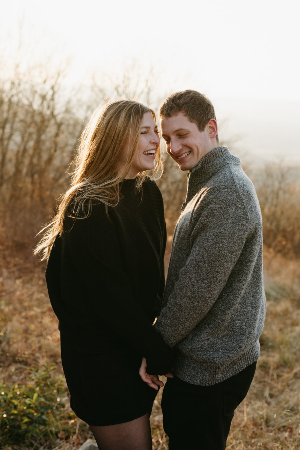 engagement session outfits fall couple hugging lauging