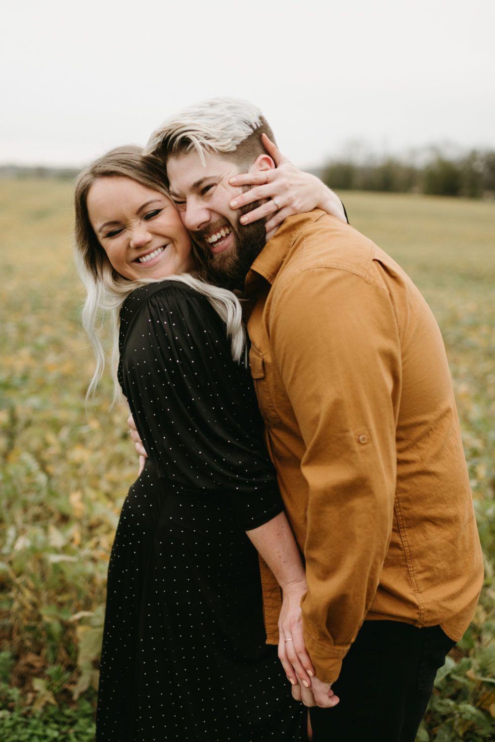 fall couple neutrals hugging smiling