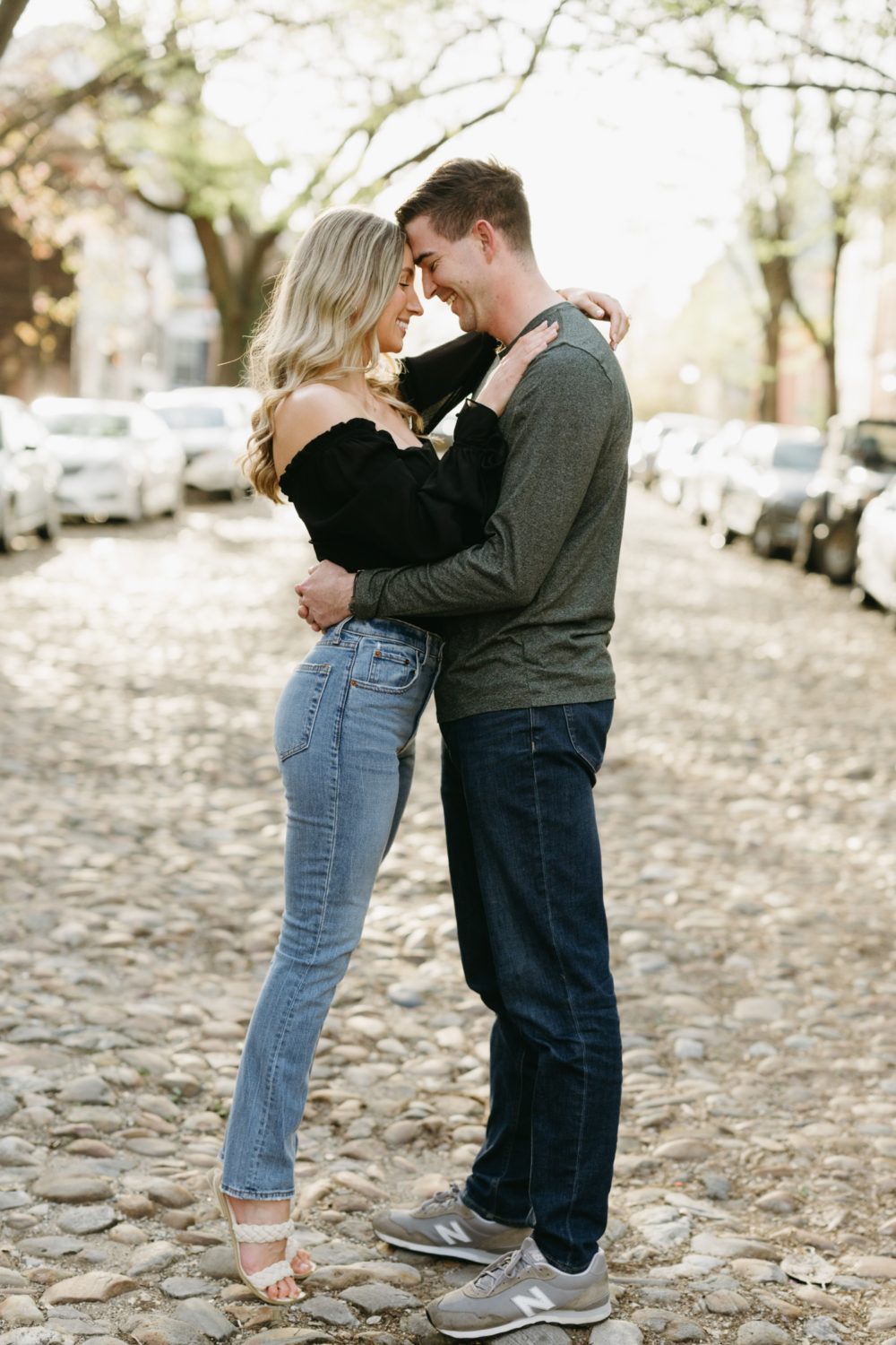 couple hugging smiling cobblestone street