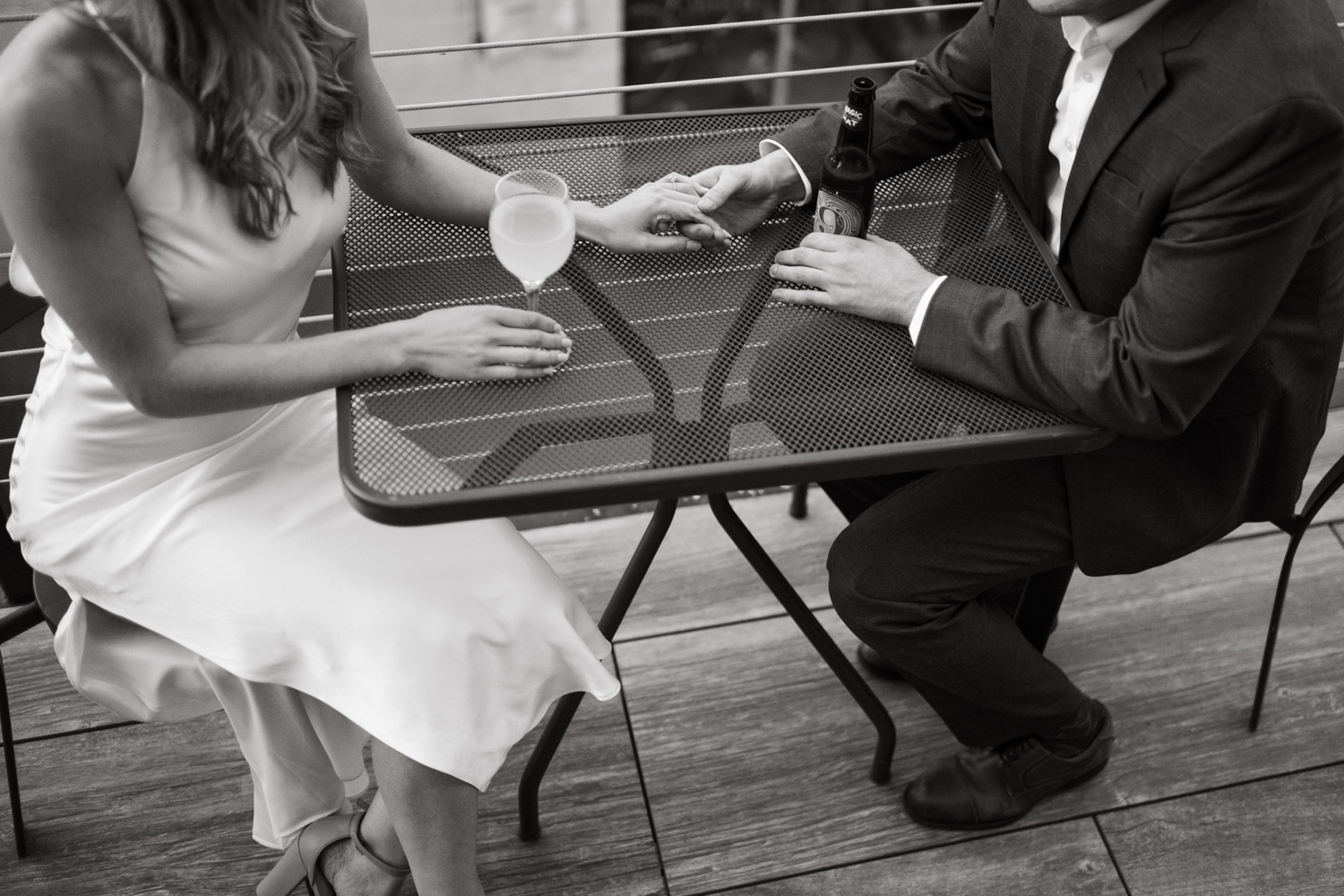 black and white couple holding hands drinks