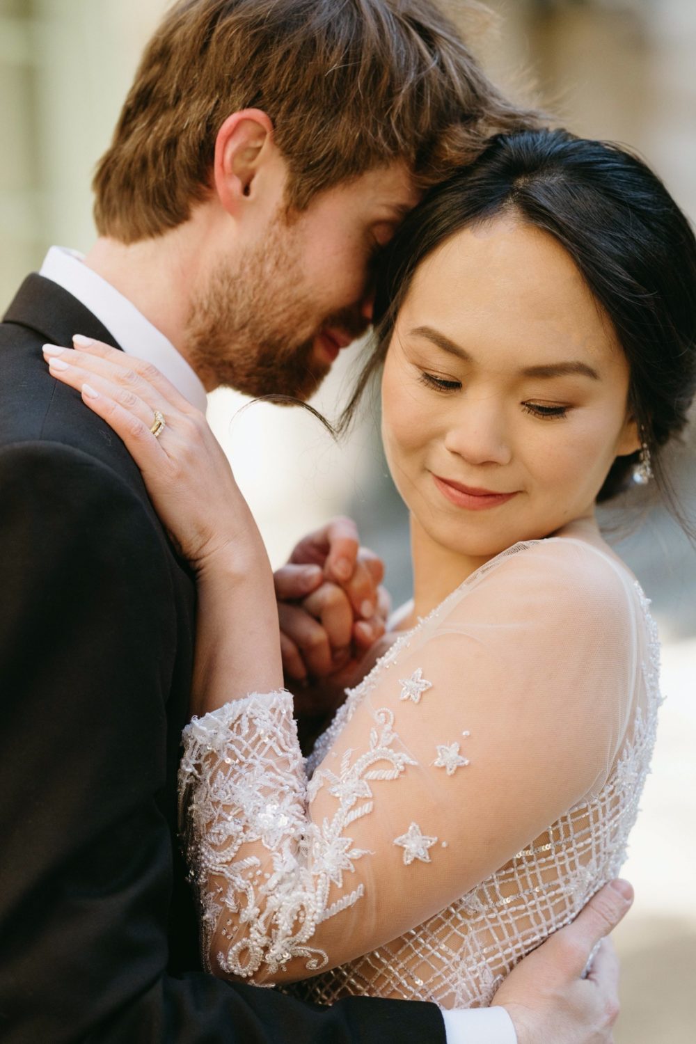 bride and groom hugging wedding dress ring details