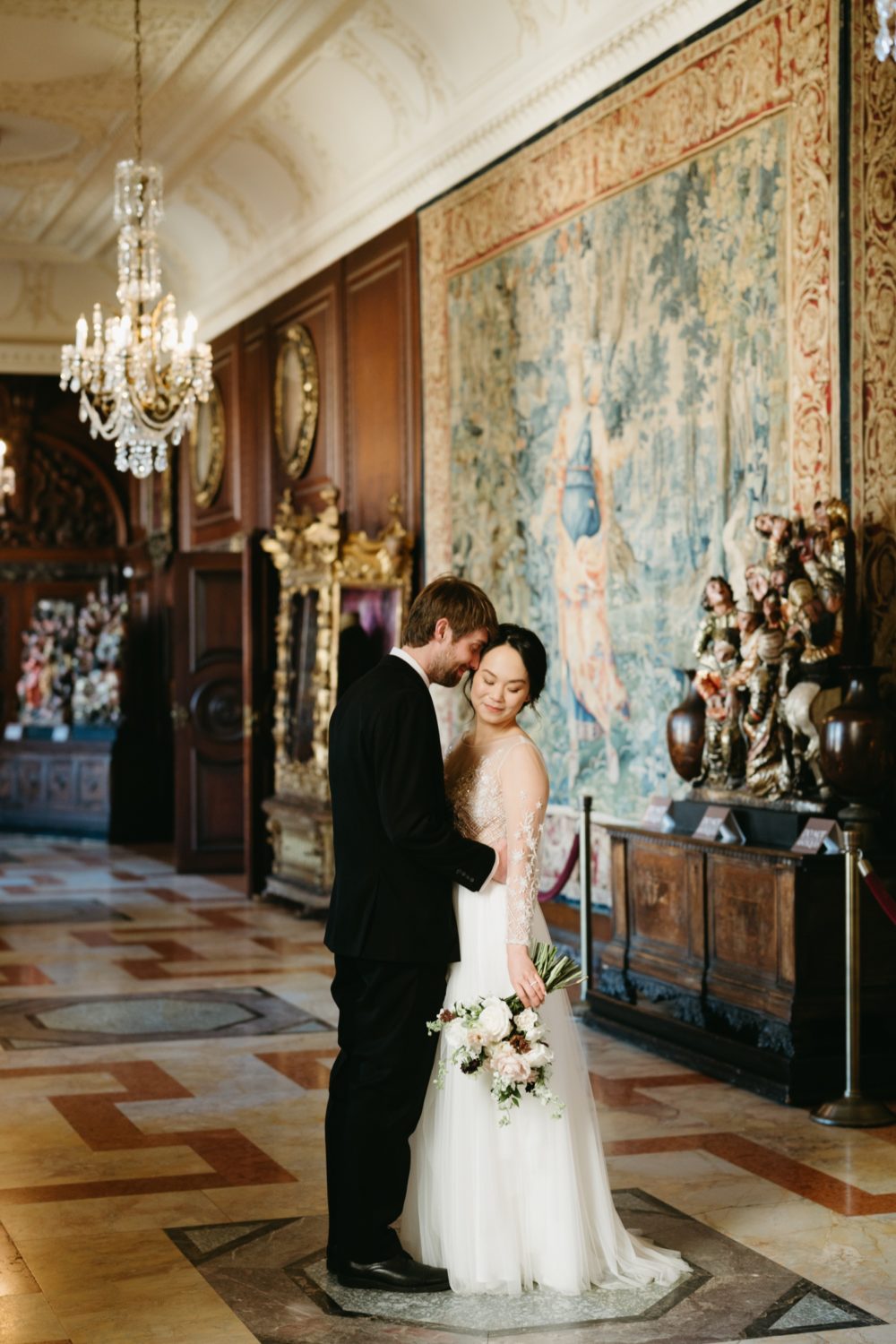intimate wedding larz anderson house bride and groom hugging artwork display