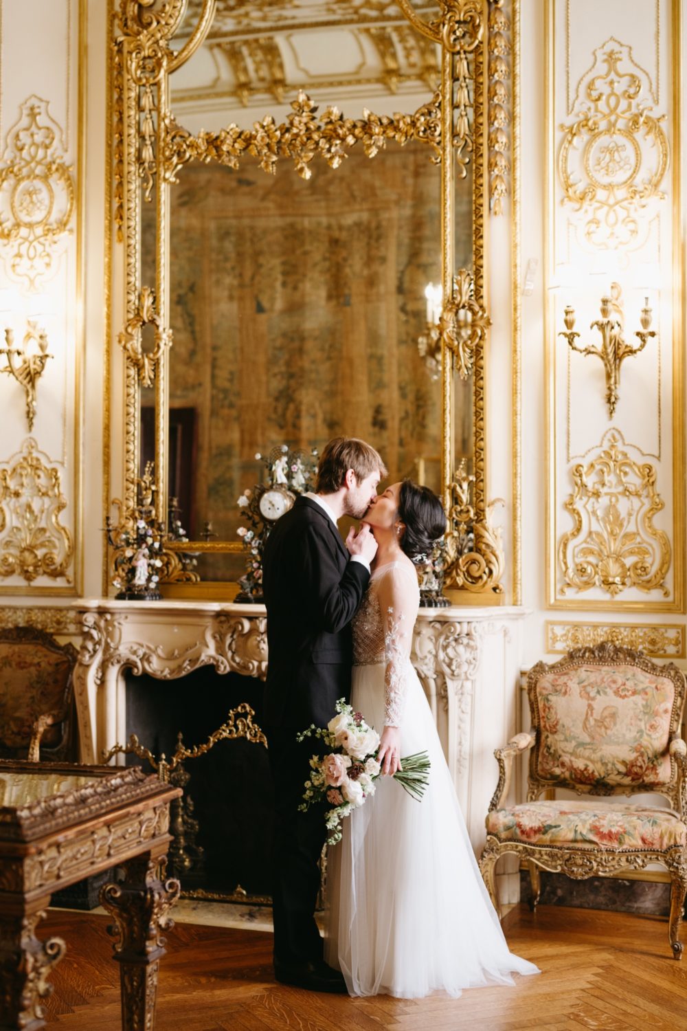 golden room bride and groom kissing