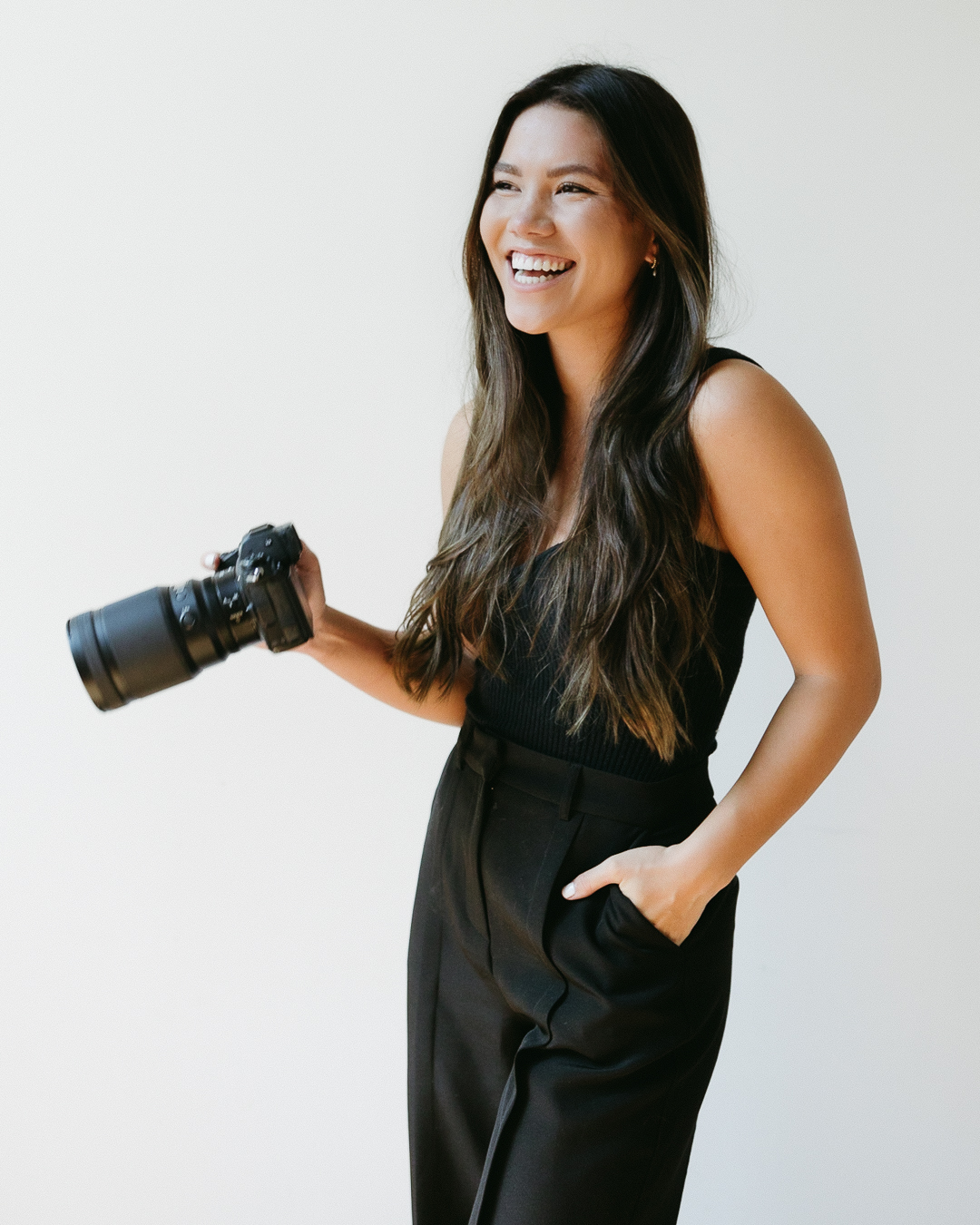 girl smiling holding camera