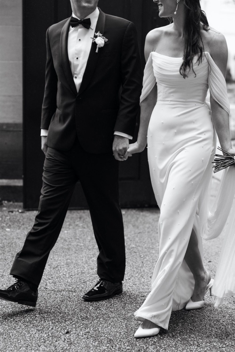 black and white bride and groom portrait holding hands