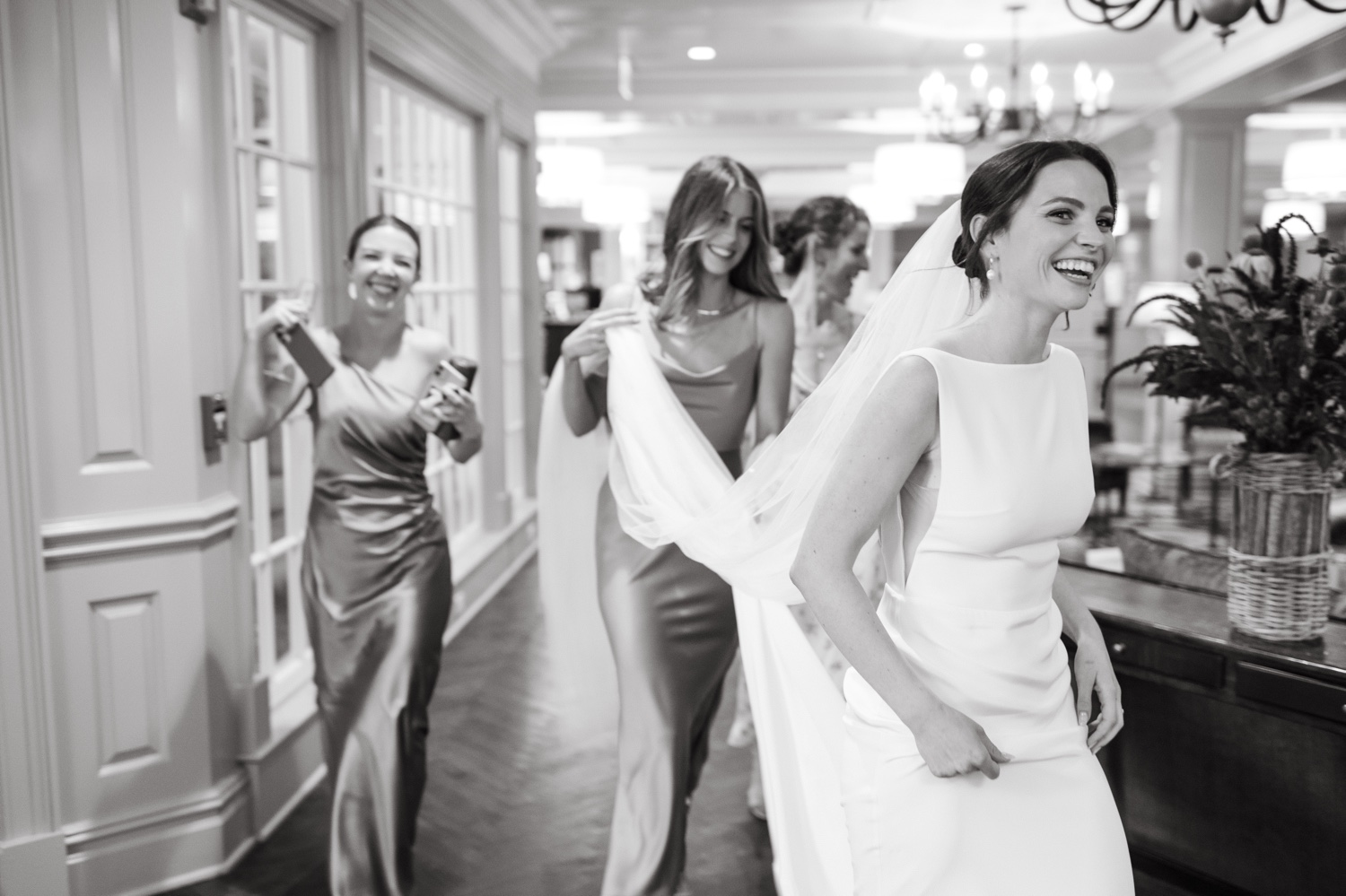 black and white woodstock inn wedding bride and bridesmaids walking