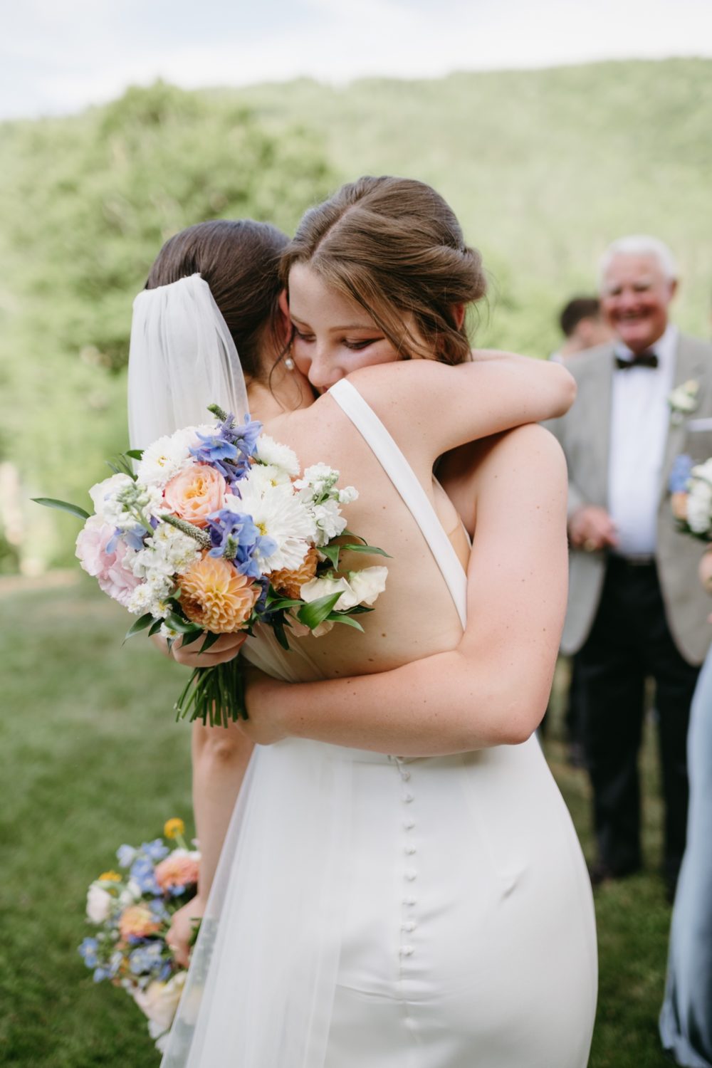 woodstock inn wedding bride hugging bouquet florals