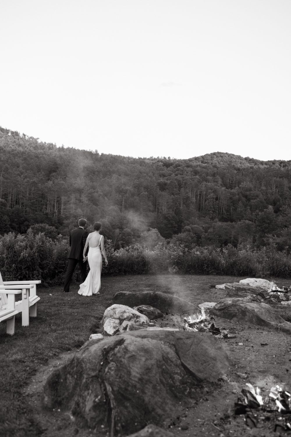 black and white bride and groom walking woodstock inn reception venue