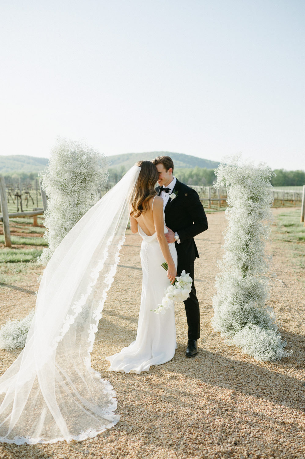 wedding fashion 2022 bride and groom hugging minimal dress lace veil