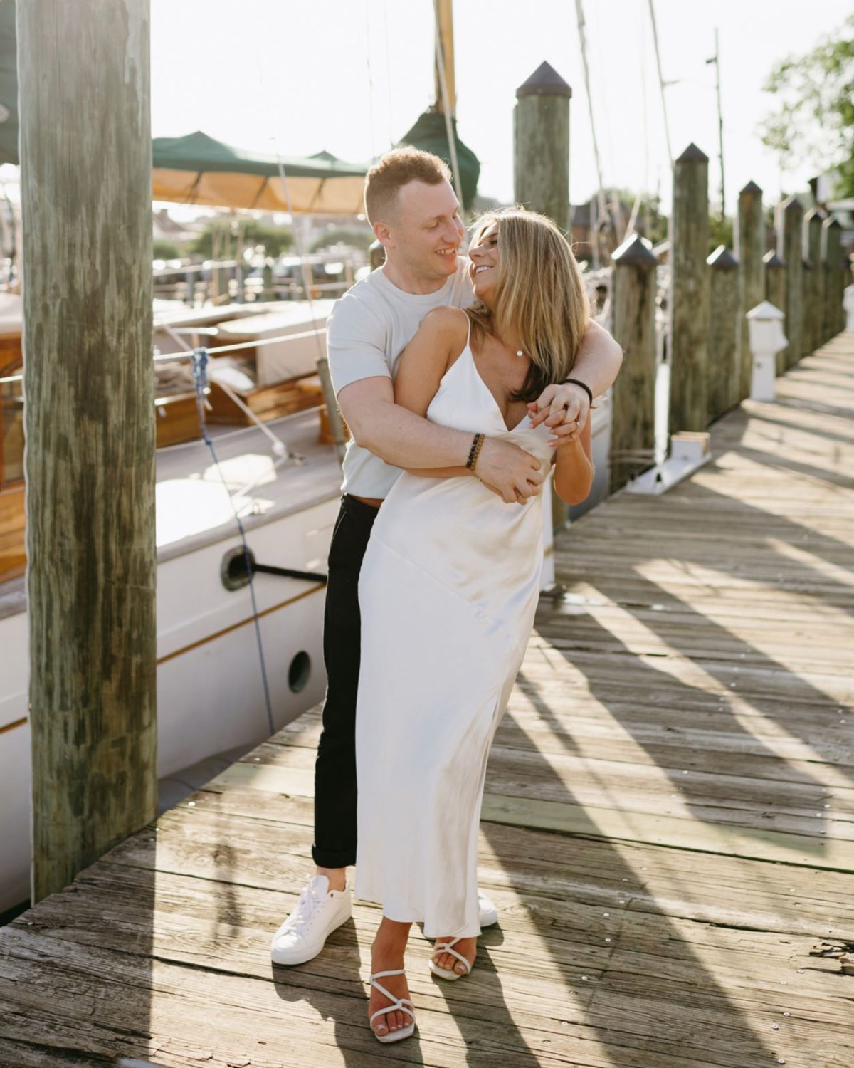 summer annapolis engagement couple hugging holding hands smiling
