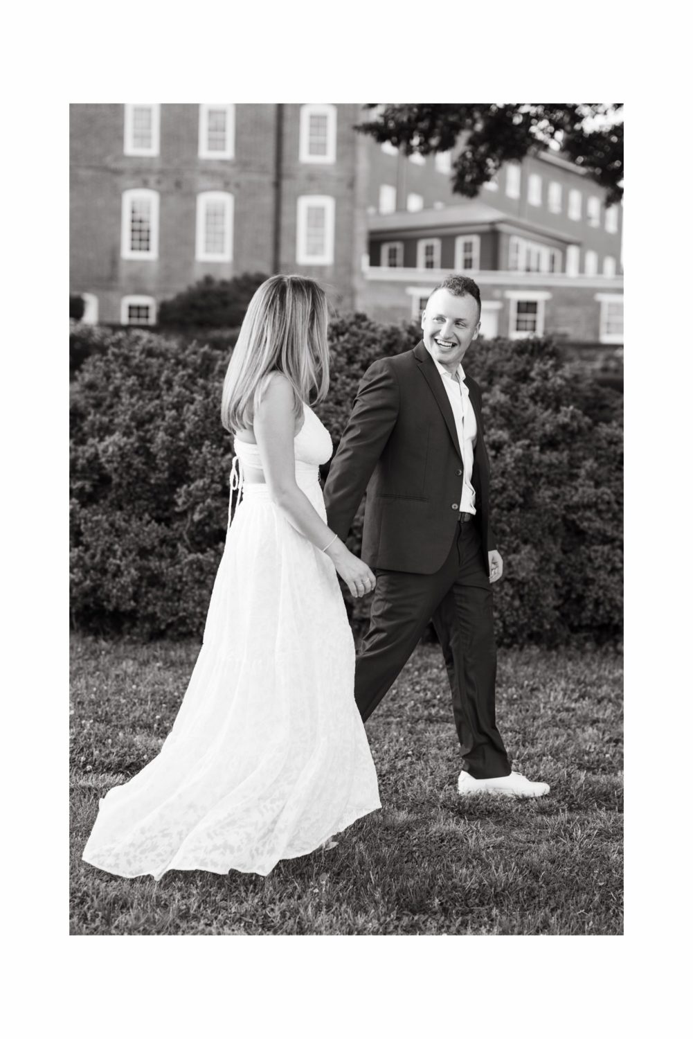 annapolis black and white portrait engaged couple holding hands smiling