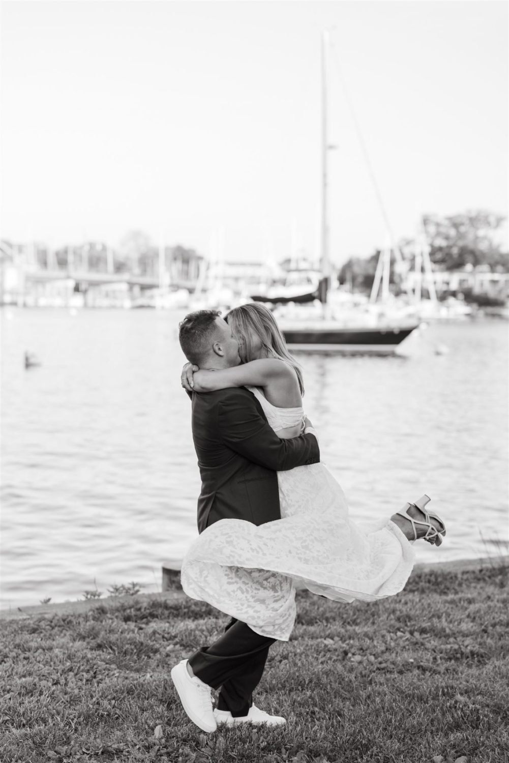 summer annapolis engagement guy and girl kissing guy holding girl black and white