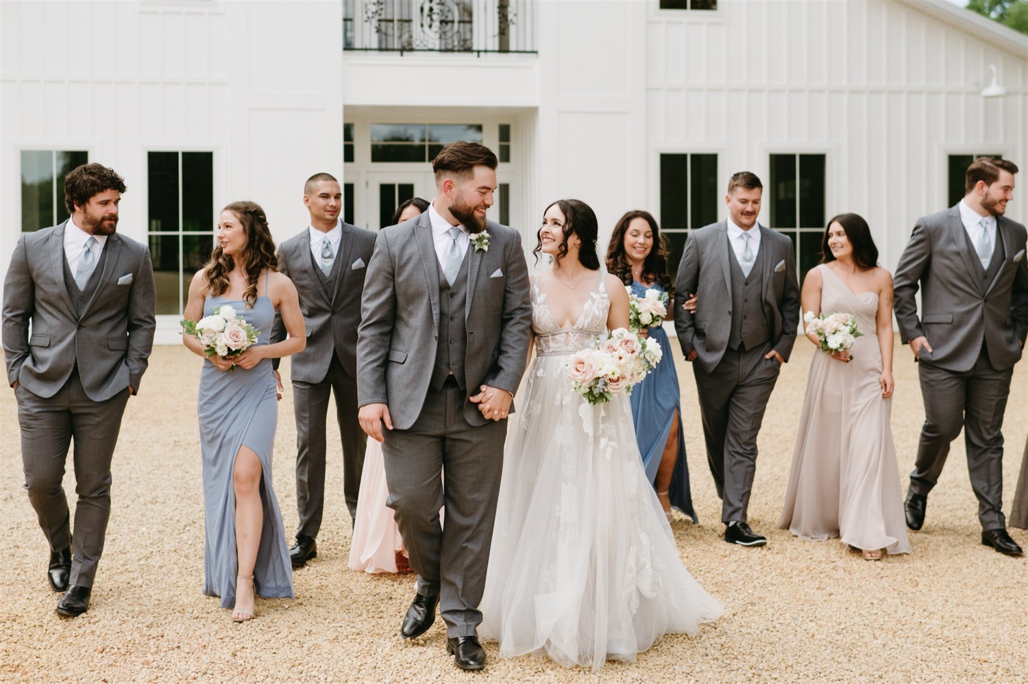 ivy rose barn bride and groom holding hands walking bridal party walking