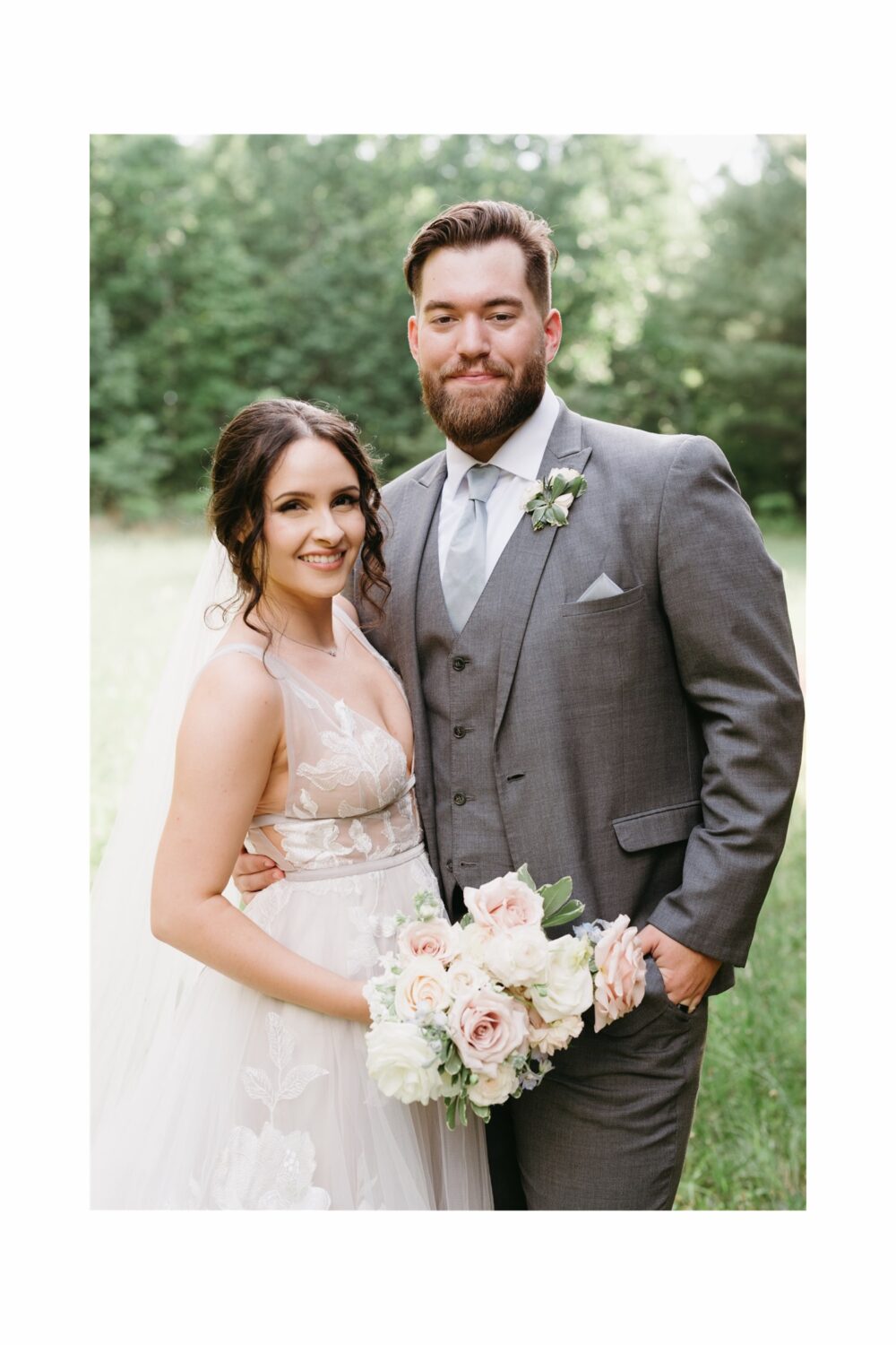 husband and wife portrait smiling floral bouquet