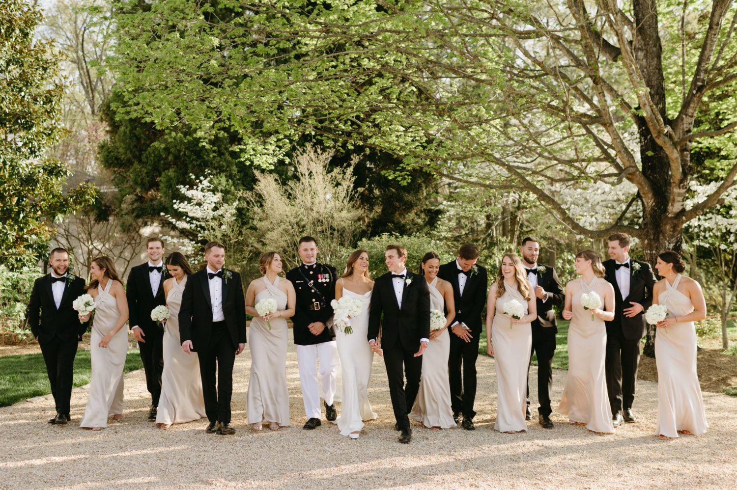 traditional bridal party attire champagne bridesmaids dresses white and black groomsmen tuxes