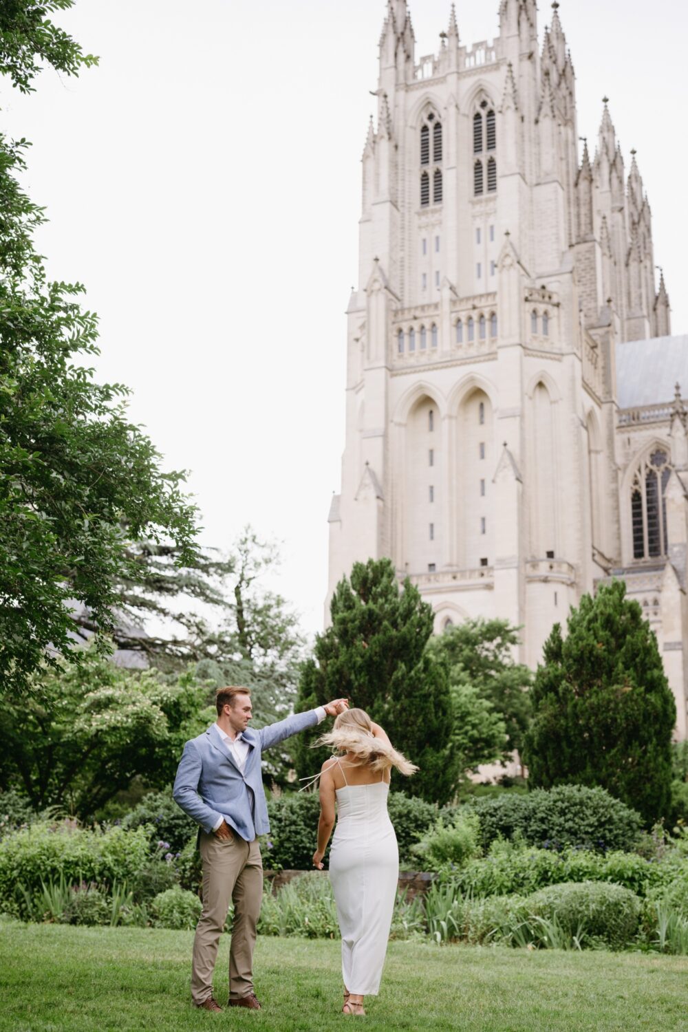 National Cathedral Engagement Session couple dancing twirling 