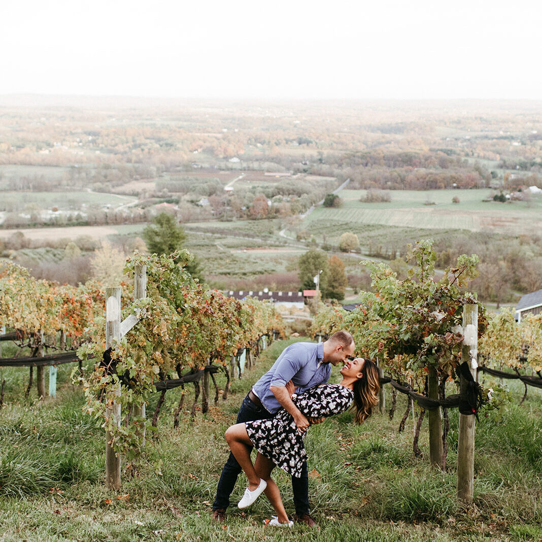 Groom dipping bride pose kissing engagement session bluemont vineyard