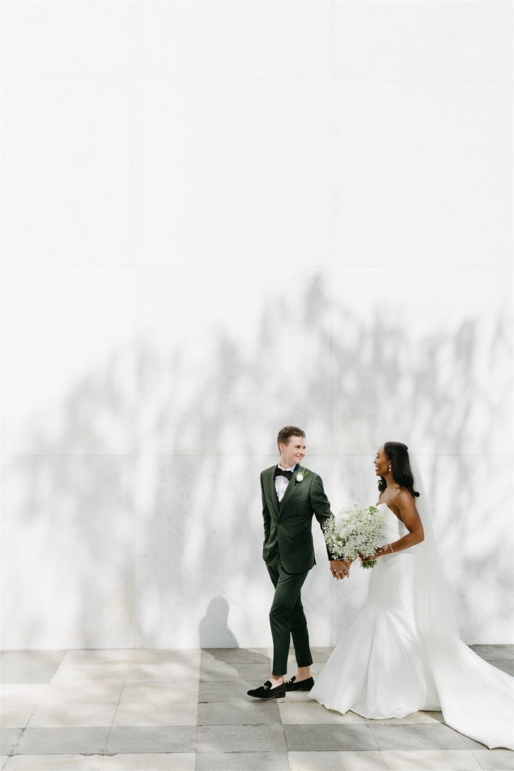 kennedy center reach bride and groom walking holding hands shadows on wall