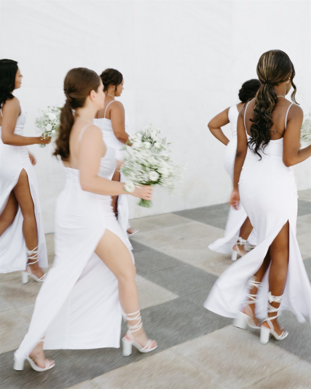 bridesmaids walking motion portrait white bridesmaid gowns white lace up shoes