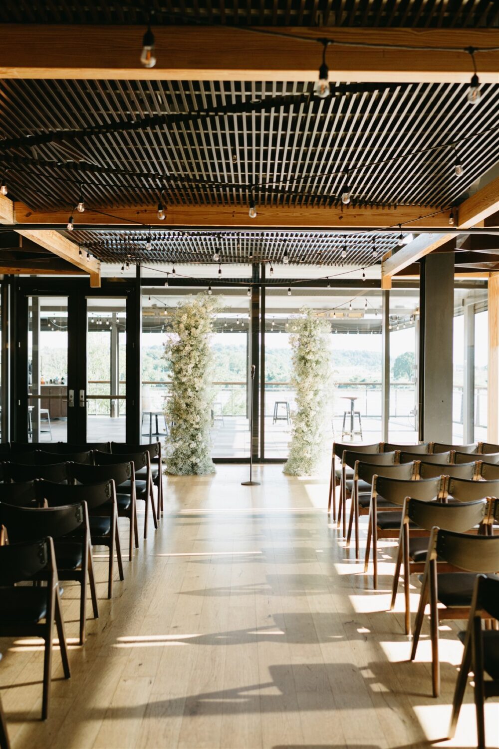 modern district winery wedding ceremony aisle white monochrome floral pillars