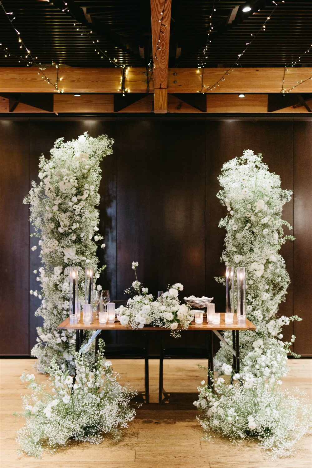 monochromatic white roses and babys breath sweetheart table 