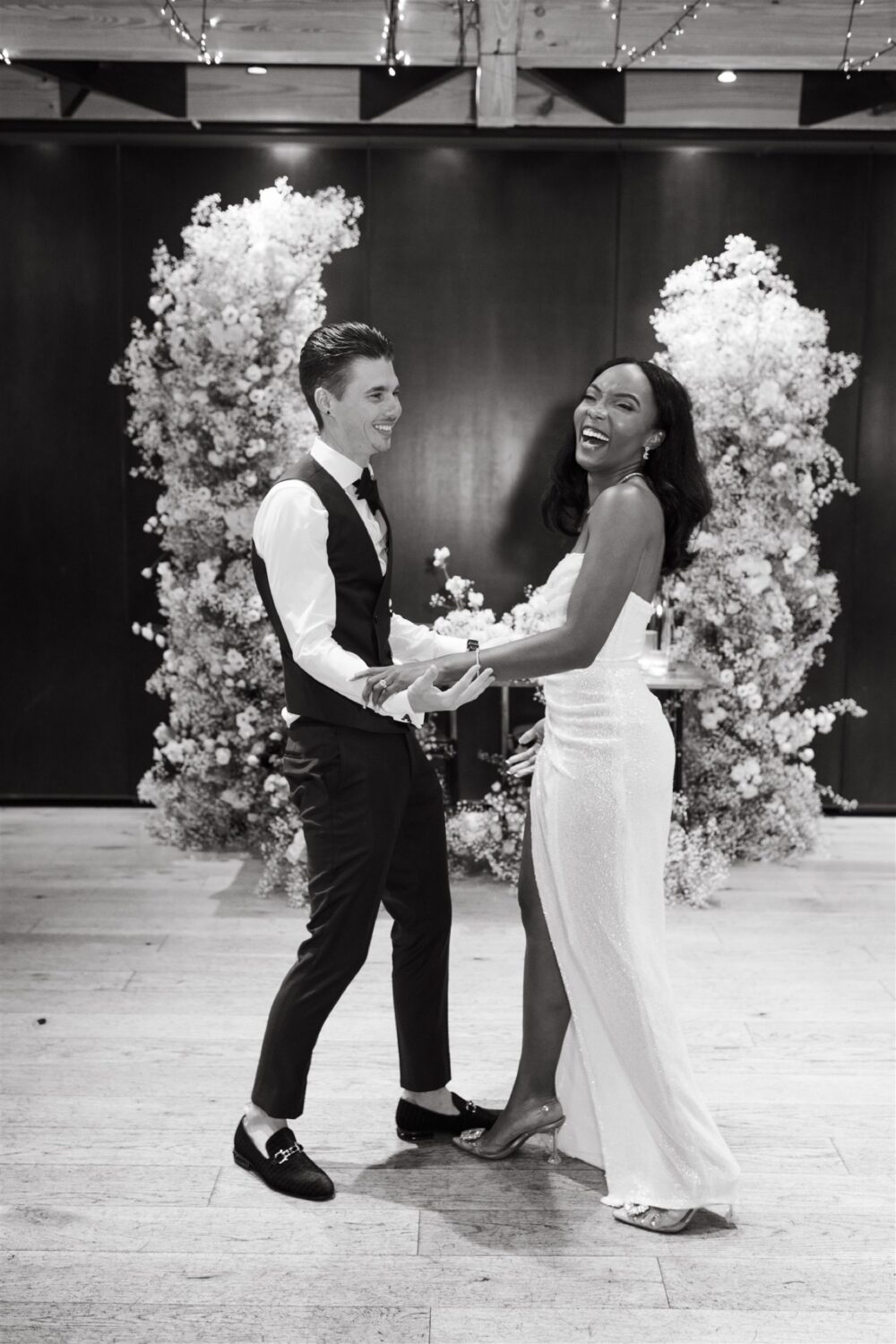 bride and groom first dance laughing romantic monochromatic wedding