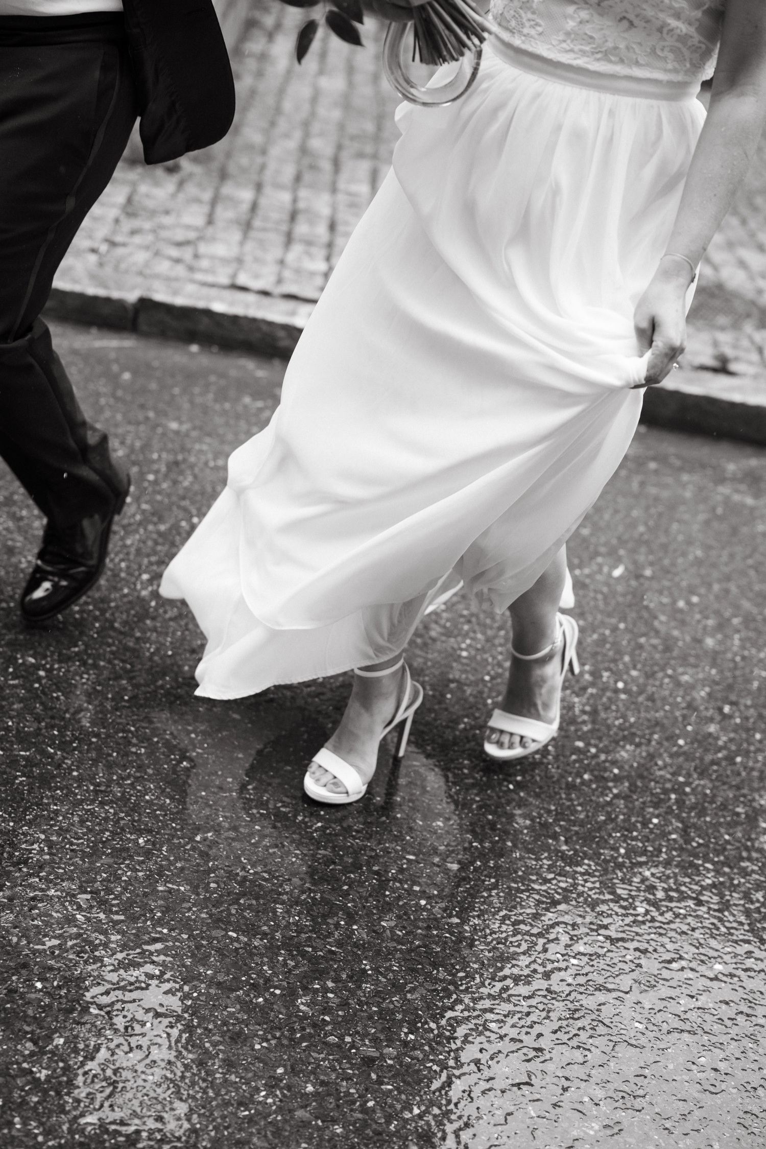 weddign shoe detail pic rainy day bride and groom walking motion shot