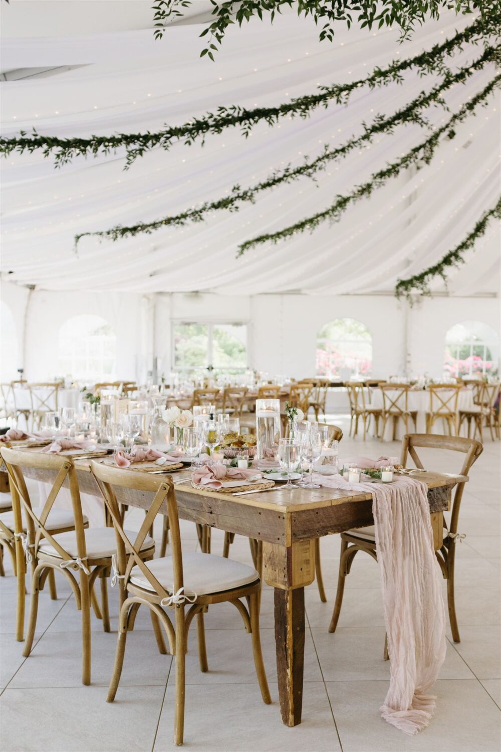 beach wedding reception tablescape inspiration wood farm tables mauve table runner white florals