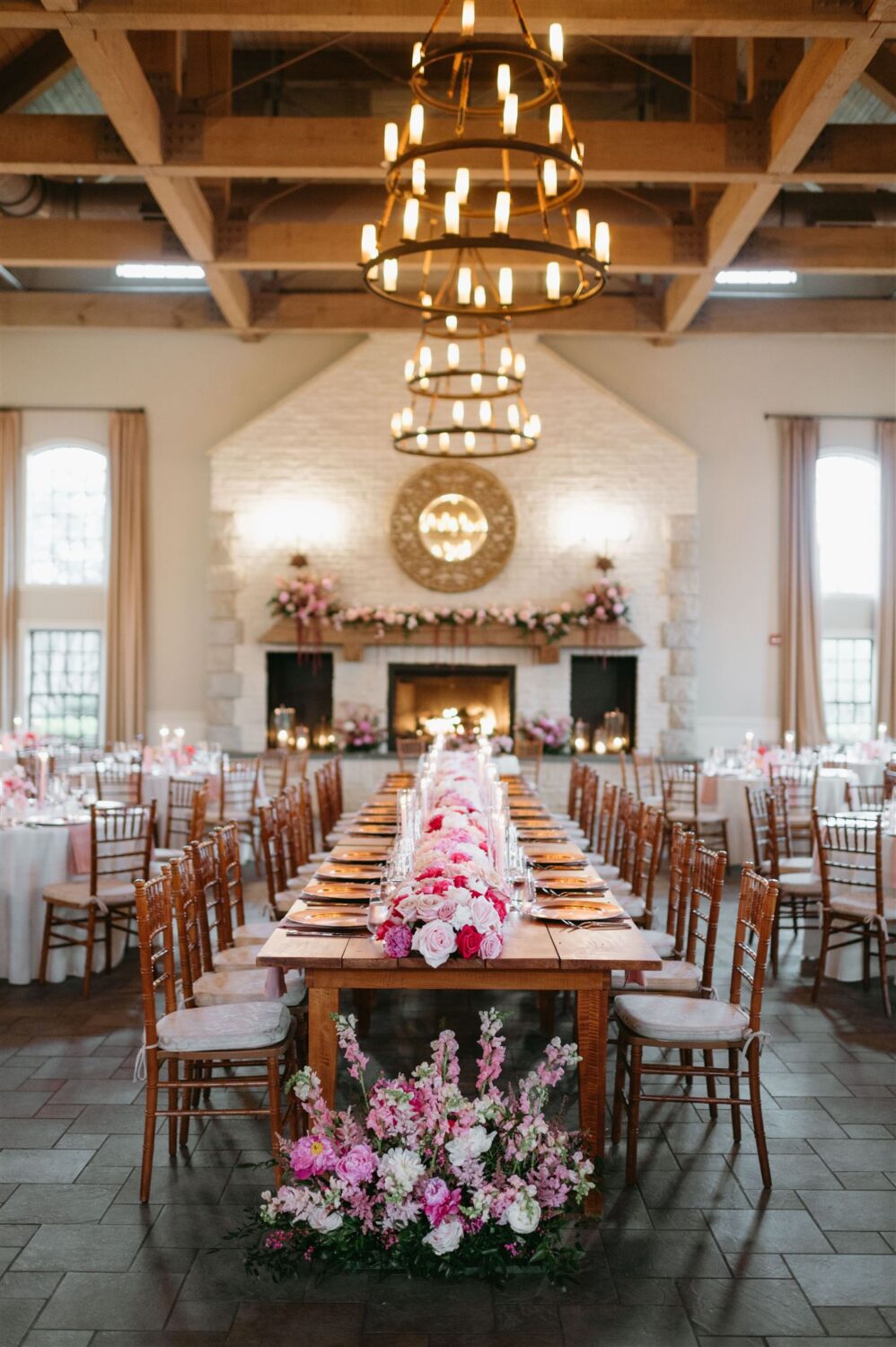 wedding reception tablescape pink centric theme pink florals hurricane glass votives