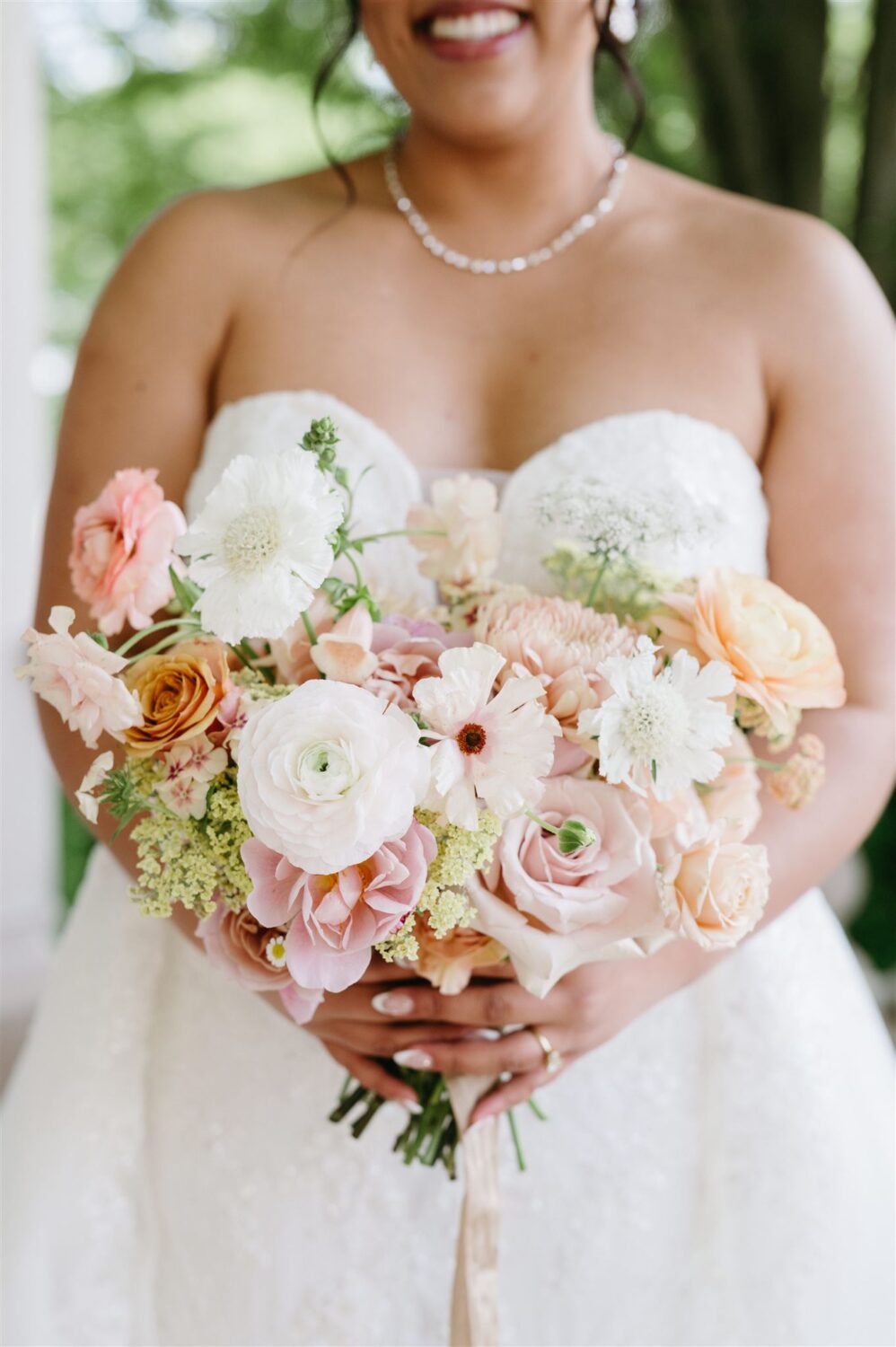 bride holding soft pink bridal bouquet