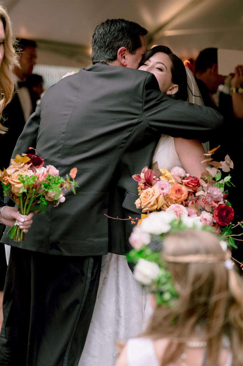 bride hugging father pink and red florals